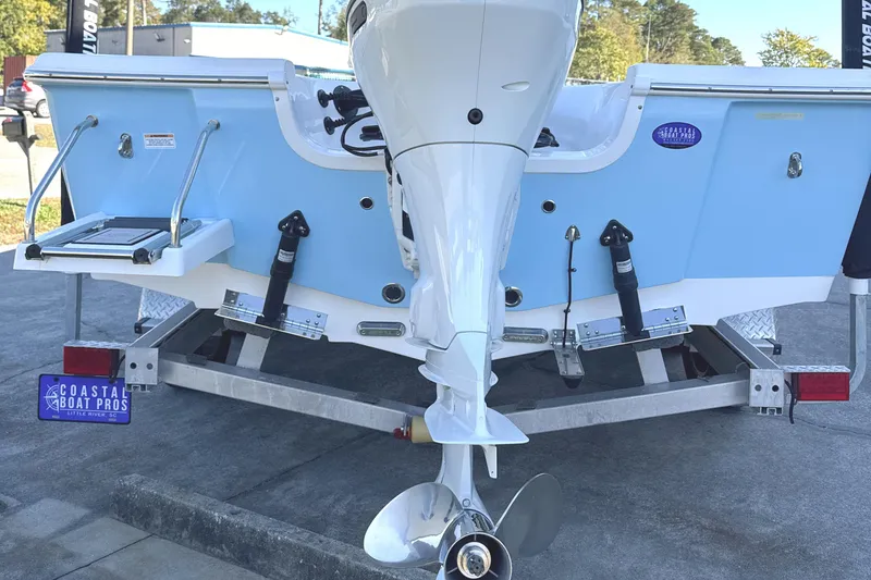Slide: The Image of 2023 Sea Pro 228 Bay boat on trailer, rear view with outboard motor. - 4
