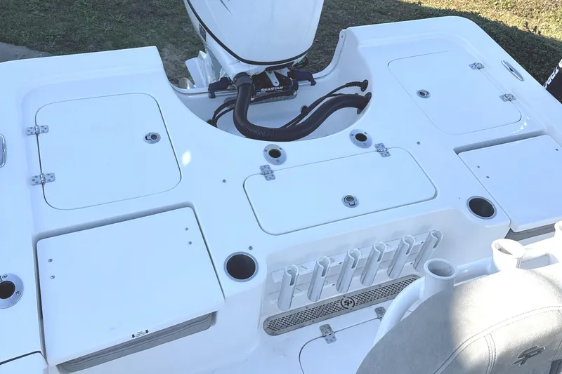 Slide: The Image of 2023 Sea Pro 228 Bay boat deck with storage compartments and rod holders. - 6