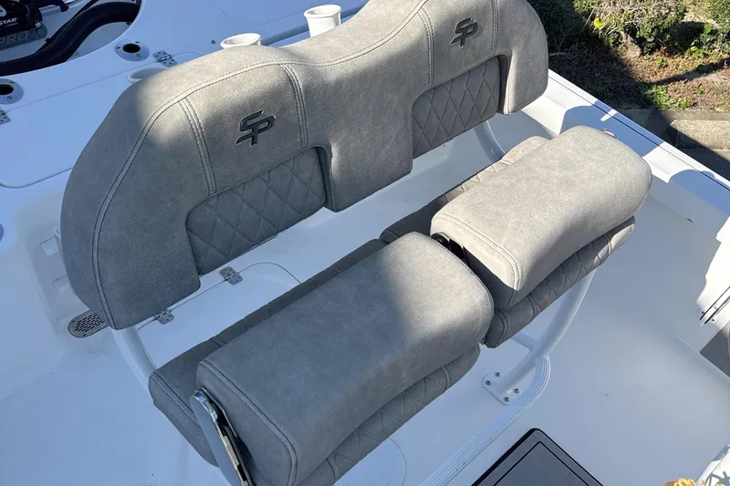 Slide: The Image of 2023 Sea Pro 228 Bay boat seating with gray upholstery and logo detailing. - 9