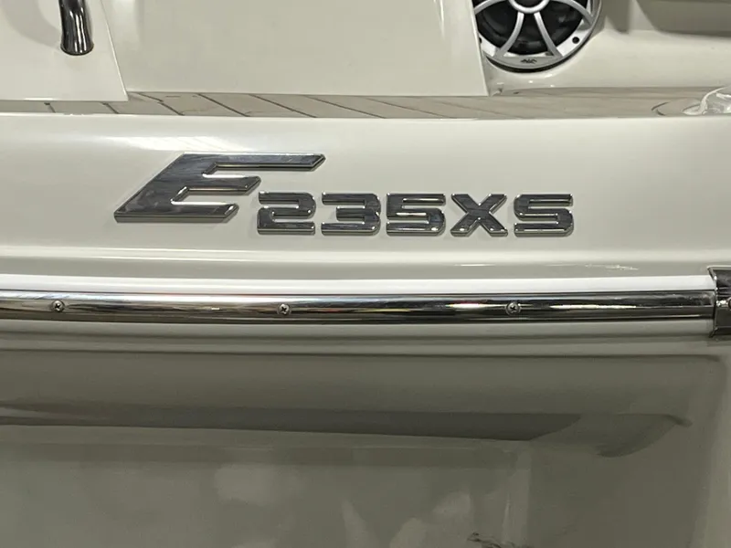 Slide: The Image of 2023 Crownline Eclipse E235 XS boat emblem on white surface. - 10