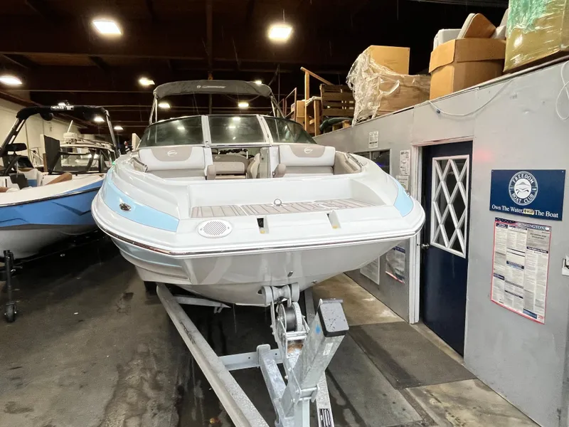 Slide: The Image of 2023 Crownline Eclipse E235 XS boat in indoor storage on a trailer. - 13