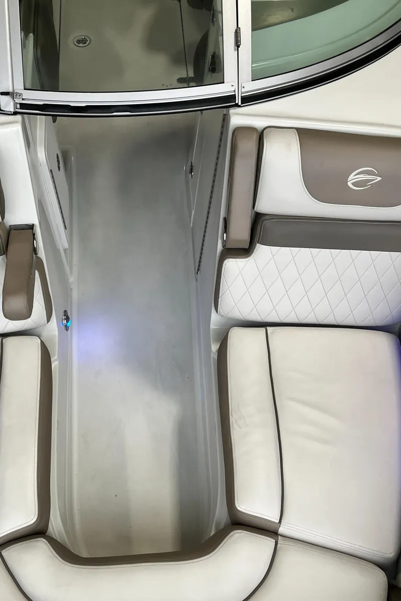 Slide: The Image of 2023 Crownline Eclipse E235 XS boat interior with beige and white seating. - 15