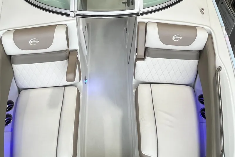 Slide: The Image of 2023 Crownline Eclipse E235 XS boat interior with white and beige seating, illuminated cup holders. - 17