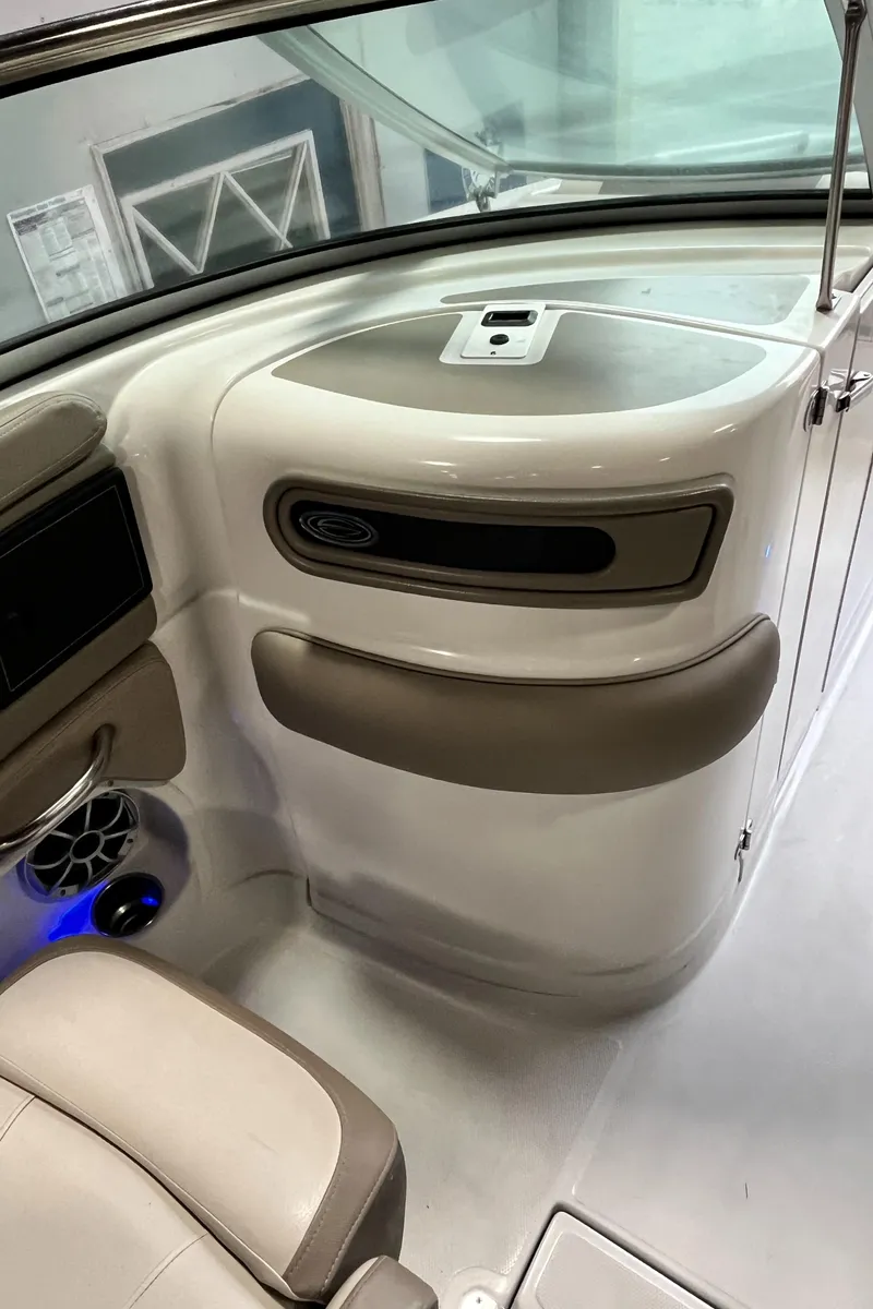 Slide: The Image of 2023 Crownline Eclipse E235 XS interior with beige seating and modern dashboard design. - 19