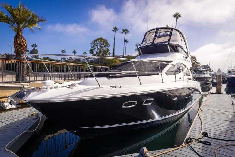 Slide: The Image of 2012 Sea Ray 450 Sedan yacht docked at marina under clear sky. - 1