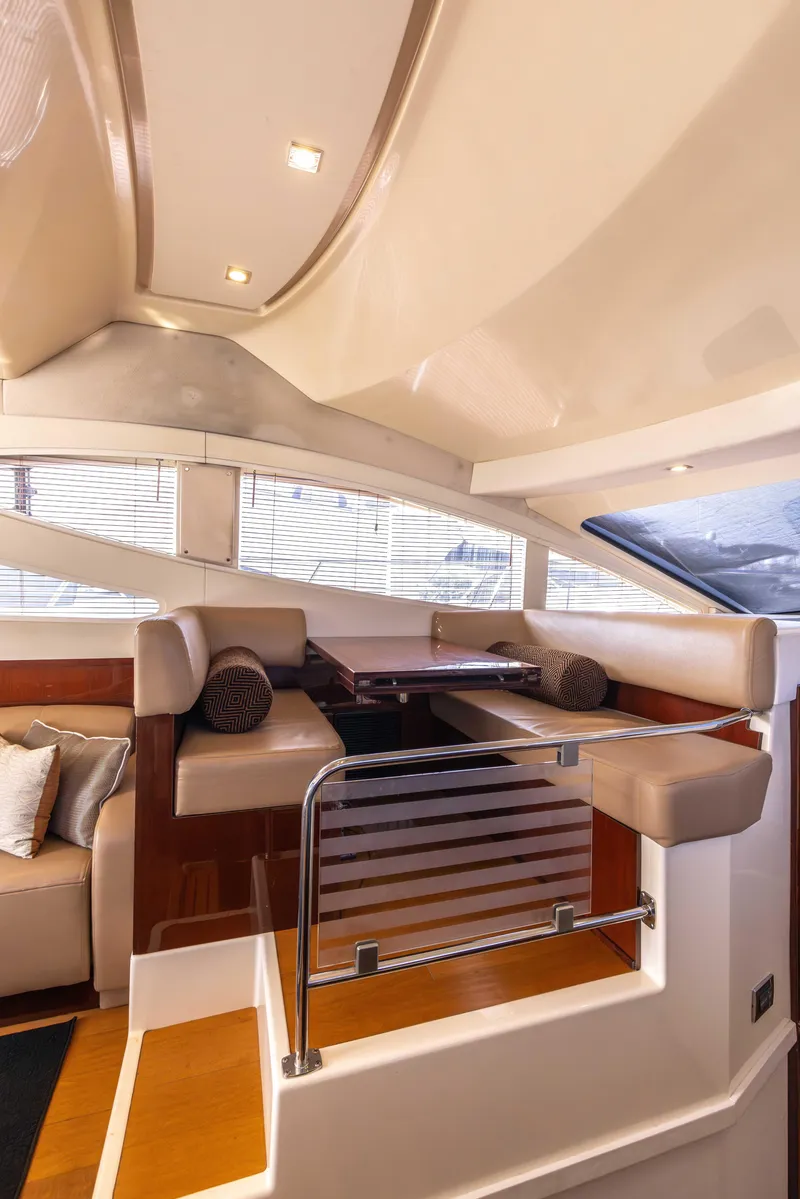 Slide: The Image of Luxurious interior of 2012 Sea Ray 450 Sedan yacht with elegant seating and dining area. - 11