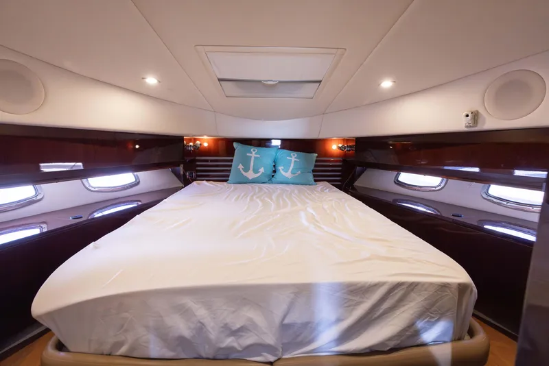 Slide: The Image of Luxurious bedroom in 2012 Sea Ray 450 Sedan yacht with anchor-themed pillows. - 17