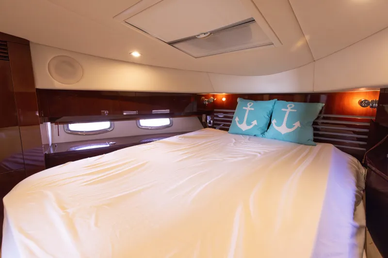 Slide: The Image of Luxurious bedroom in 2012 Sea Ray 450 Sedan yacht with anchor-themed pillows. - 18