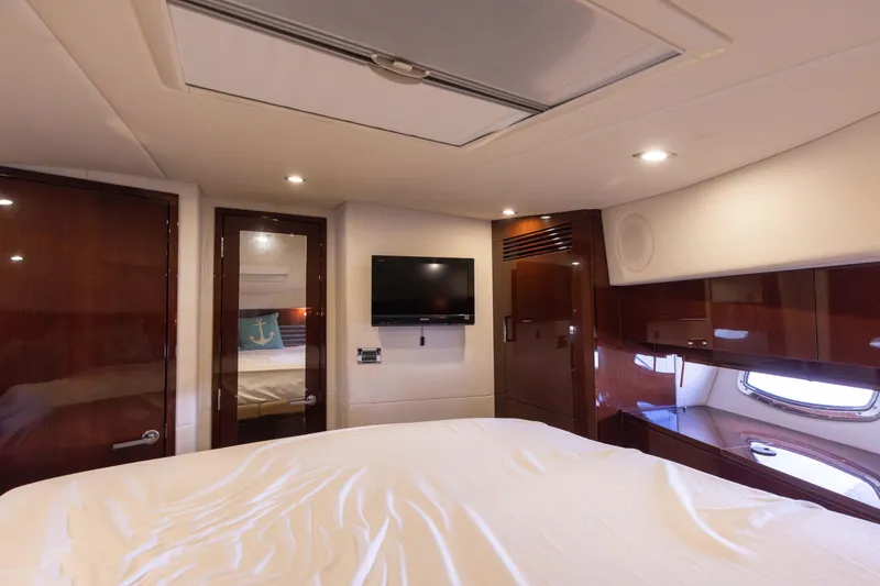 Slide: The Image of Luxurious interior of 2012 Sea Ray 450 Sedan yacht with TV and wood finishes. - 20