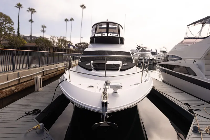 Slide: The Image of 2012 Sea Ray 450 Sedan yacht docked at marina, front view. - 27