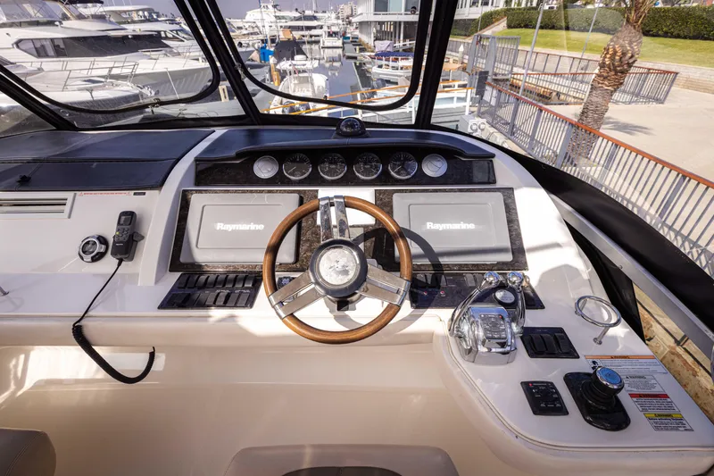 Slide: The Image of Cockpit of 2012 Sea Ray 450 Sedan with modern navigation equipment and steering wheel. - 4