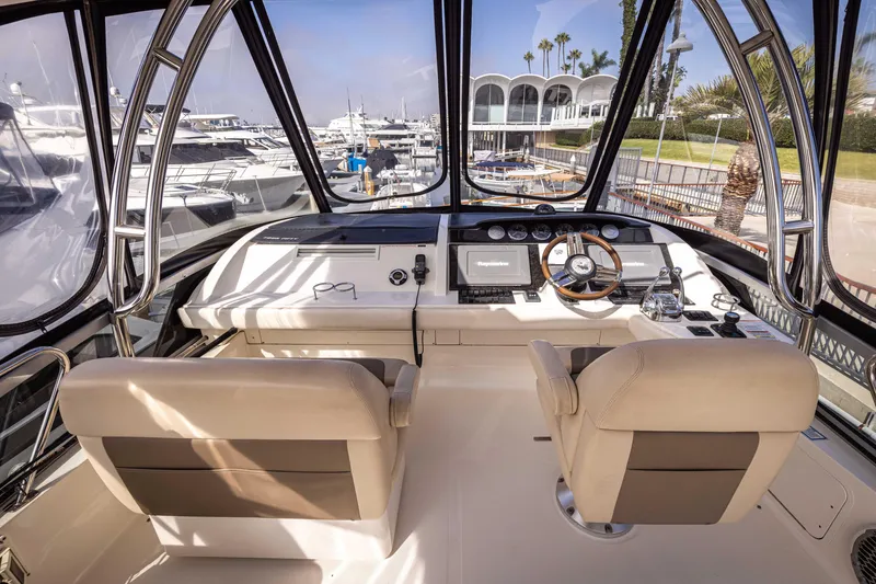 Slide: The Image of Interior view of 2012 Sea Ray 450 Sedan yacht cockpit with dual seats and control panel. - 5