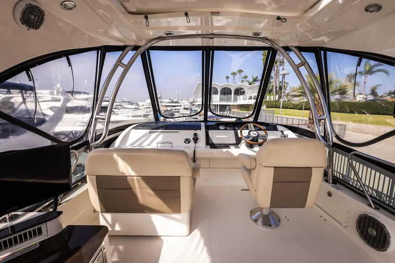 Slide: The Image of Interior view of 2012 Sea Ray 450 Sedan yacht cockpit with marina background. - 6