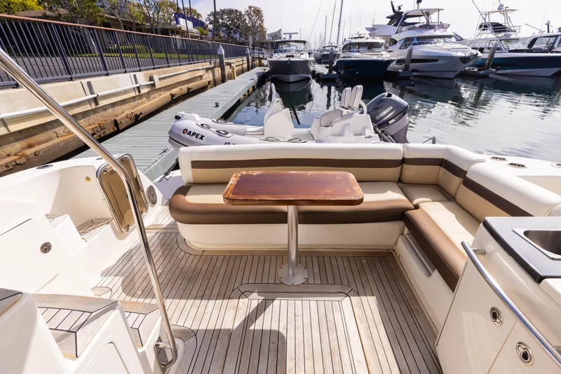 Slide: The Image of 2012 Sea Ray 450 Sedan yacht interior with seating and table at marina. - 8