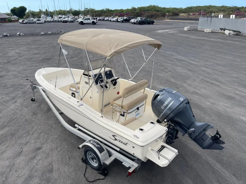 Slide: The Image of 2024 Scout 175 Sportfish boat with Yamaha engine on trailer, parked outdoors. - 5