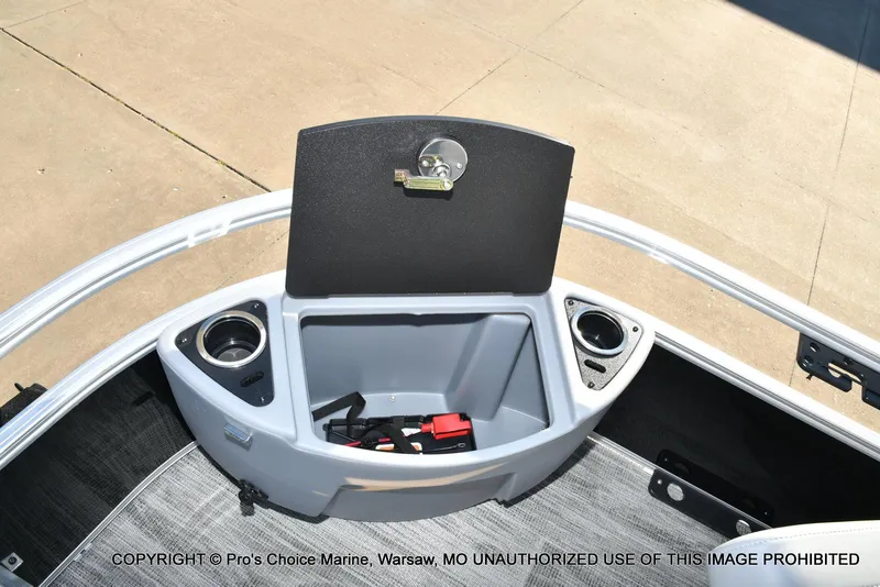 Slide: The Image of 2024 Ranger 220F boat storage compartment with cup holders and accessories. - 33