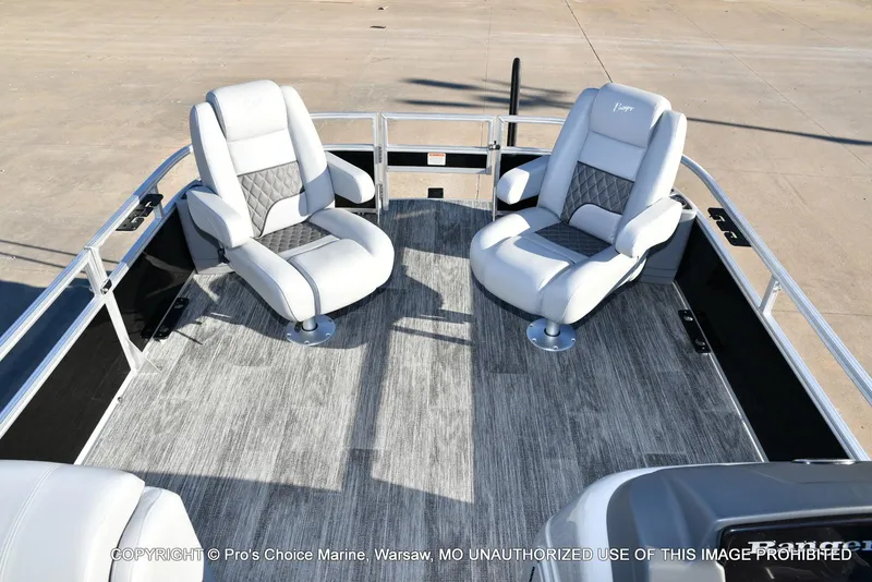 Slide: The Image of 2024 Ranger 220F boat interior with two plush captain's chairs on a sleek deck. - 6