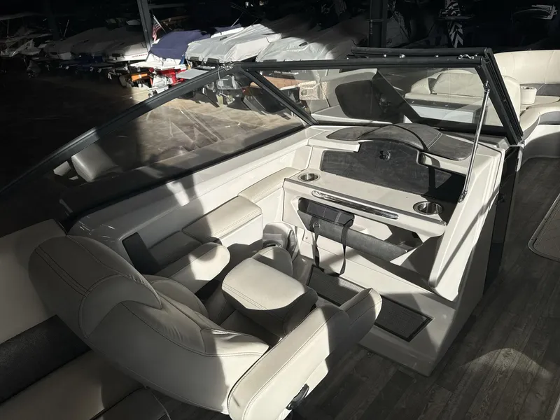 Slide: The Image of Interior of 2018 Crest Continental boat with beige seating and dashboard. - 14