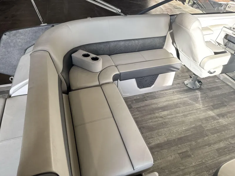 Slide: The Image of 2018 Crest Continental boat interior with gray seating and wood-style flooring. - 15