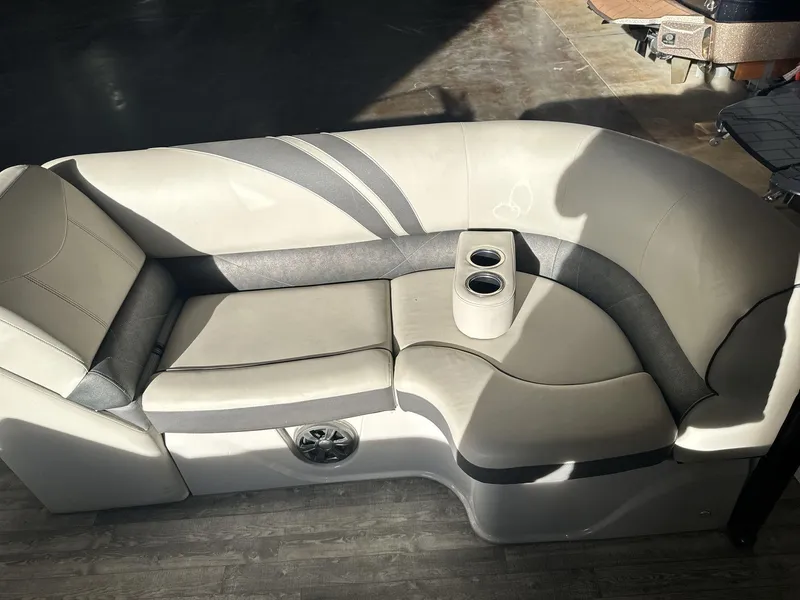 Slide: The Image of 2018 Crest CONTINENTAL boat seating with cup holders, gray and beige upholstery. - 17