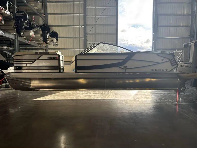 Slide: The Image of 2018 Crest Continental pontoon boat in storage facility, side view. - 4
