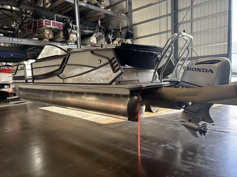 Slide: The Image of 2018 Crest Continental pontoon boat with Honda outboard motor in storage facility. - 5