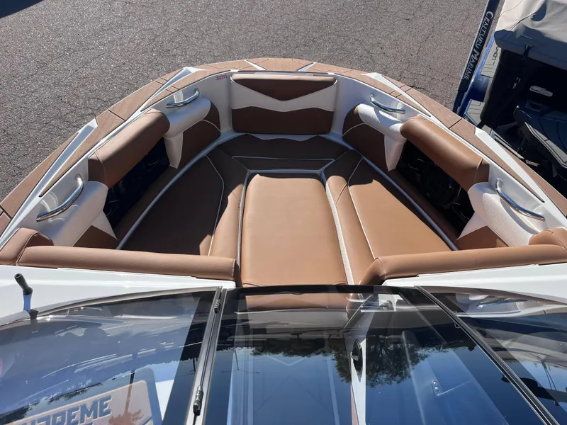 Slide: The Image of 2025 Supreme S240 boat interior with brown leather seating and sleek design. - 12