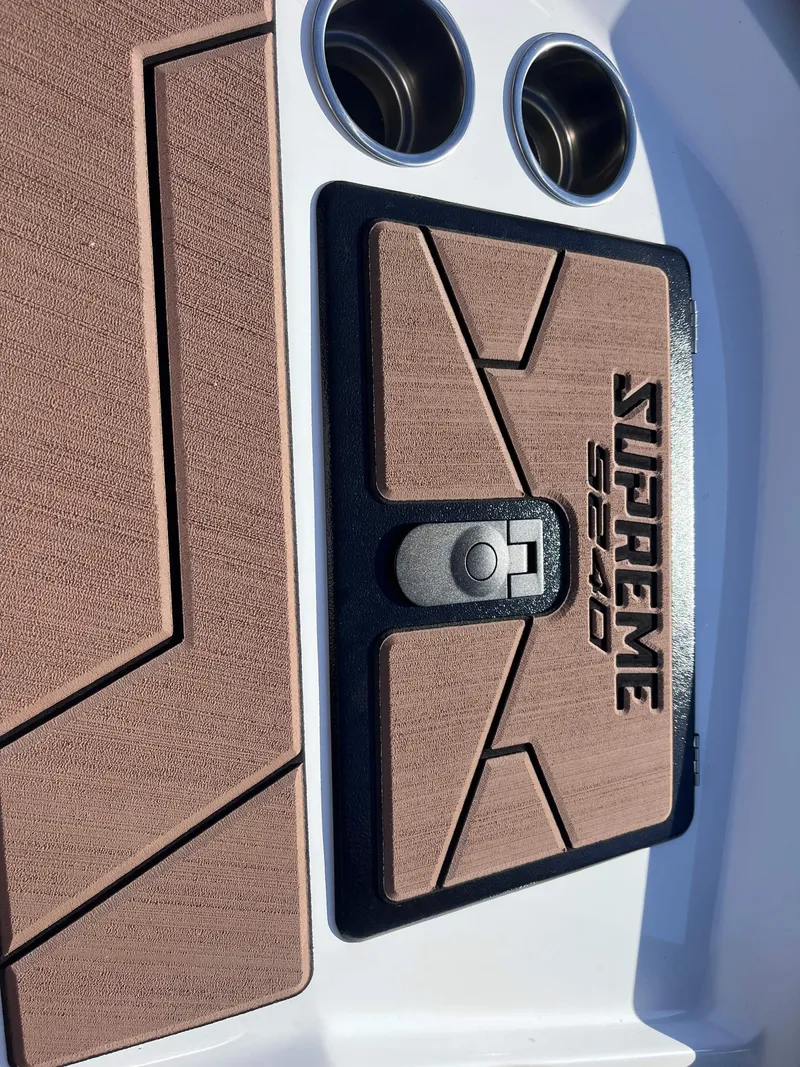 Slide: The Image of Supreme S240 2025 boat deck with cup holders and textured surface. - 13