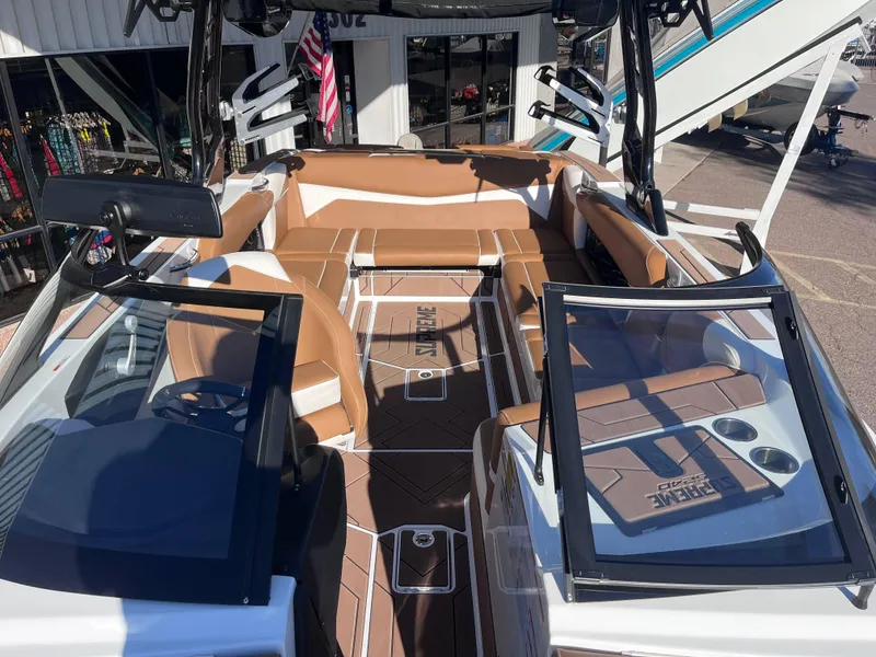 Slide: The Image of 2025 Supreme S240 boat interior with tan seating and sleek design. - 14