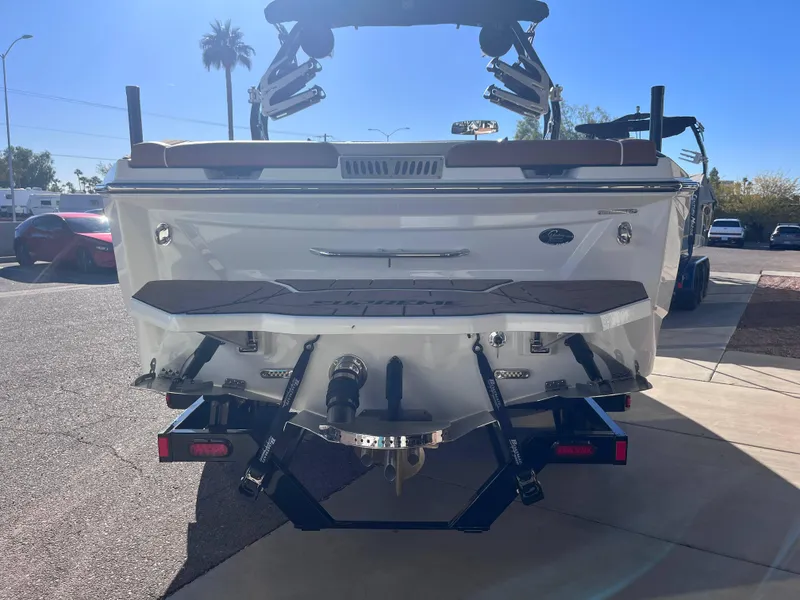 Slide: The Image of 2025 Supreme S240 boat rear view in sunny outdoor setting. - 3