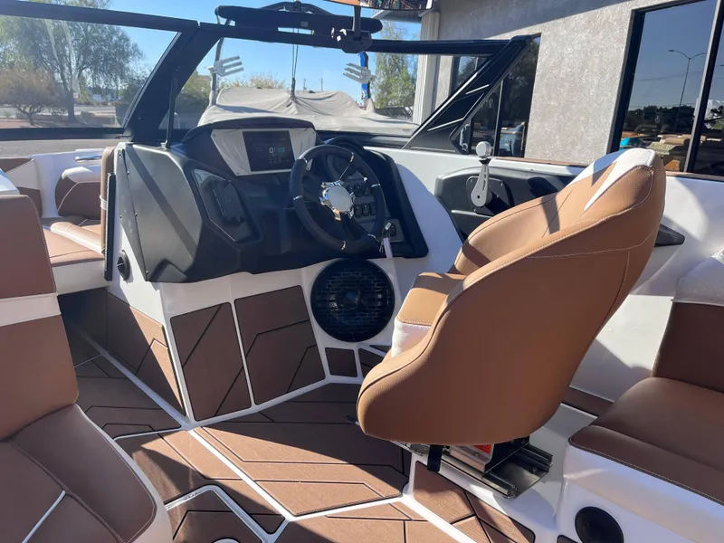 Slide: The Image of Interior of 2025 Supreme S240 boat with modern dashboard and brown seating. - 7