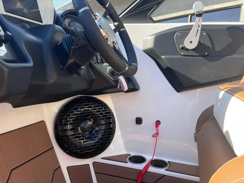 Slide: The Image of 2025 Supreme S240 boat interior with steering wheel and speaker system. - 8