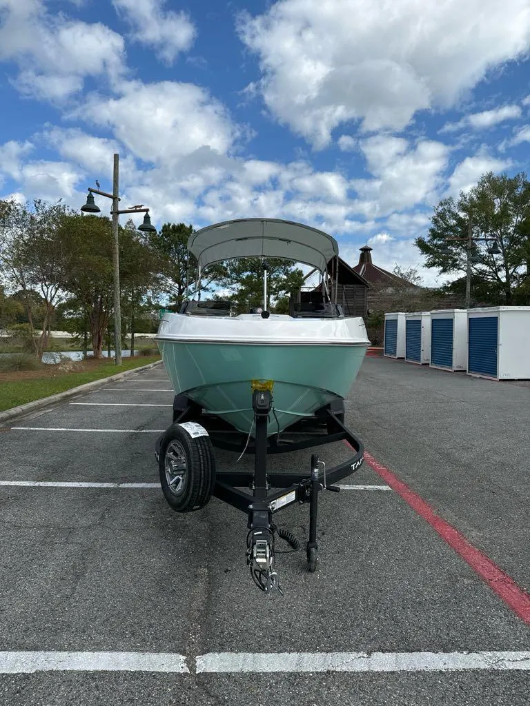 Slide: The Image of 2025 Tahoe T21 boat on trailer in parking lot under cloudy sky. - 3