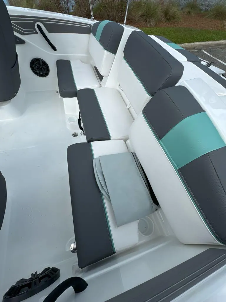 Slide: The Image of 2025 Tahoe T21 boat interior with gray and teal seating. - 6