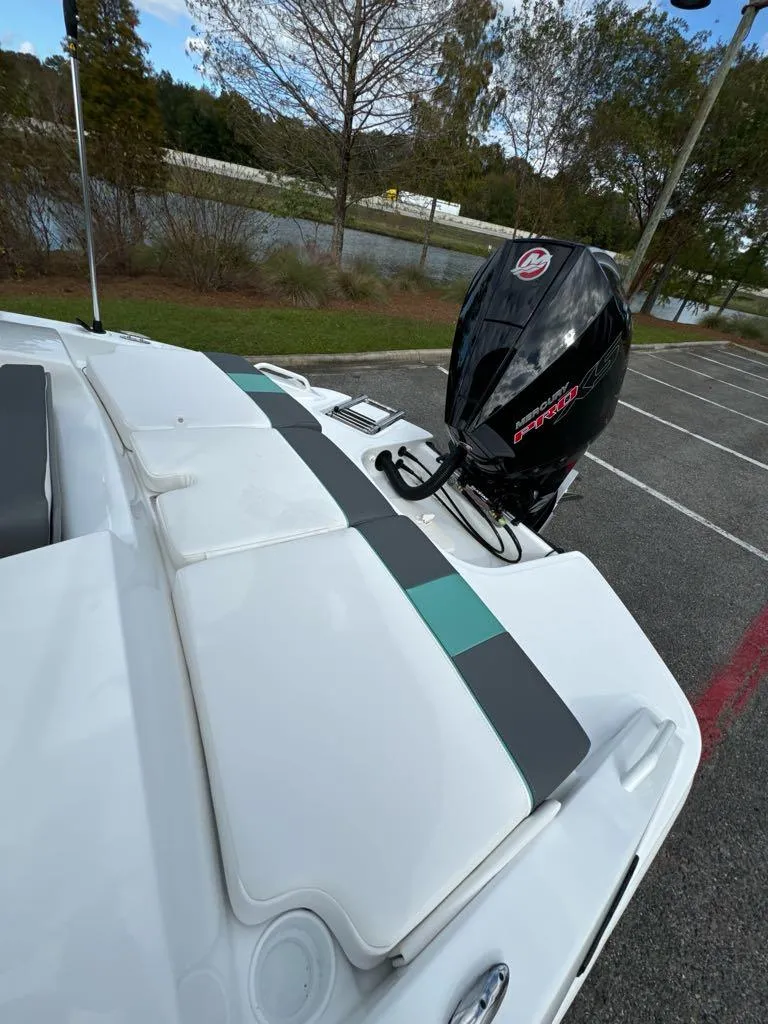 Slide: The Image of 2025 Tahoe T21 boat with outboard motor in a parking lot. - 7