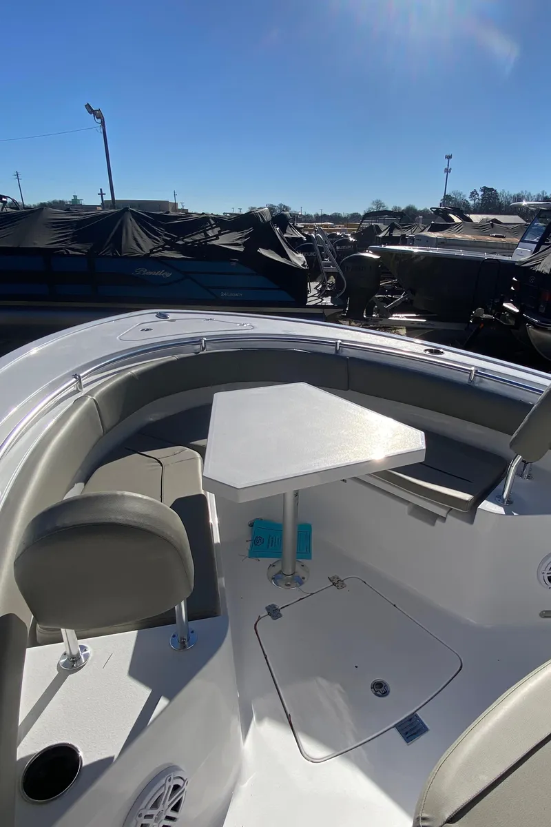 Slide: The Image of 2025 Sportsman Heritage 231 Center Console boat interior with seating and table. - 12