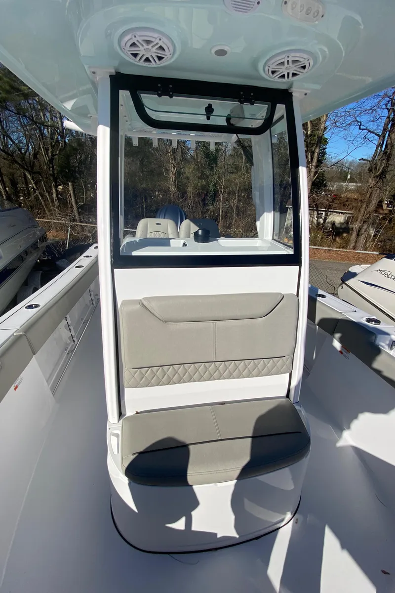 Slide: The Image of 2025 Sportsman Heritage 231 Center Console boat interior with seating and console features. - 13