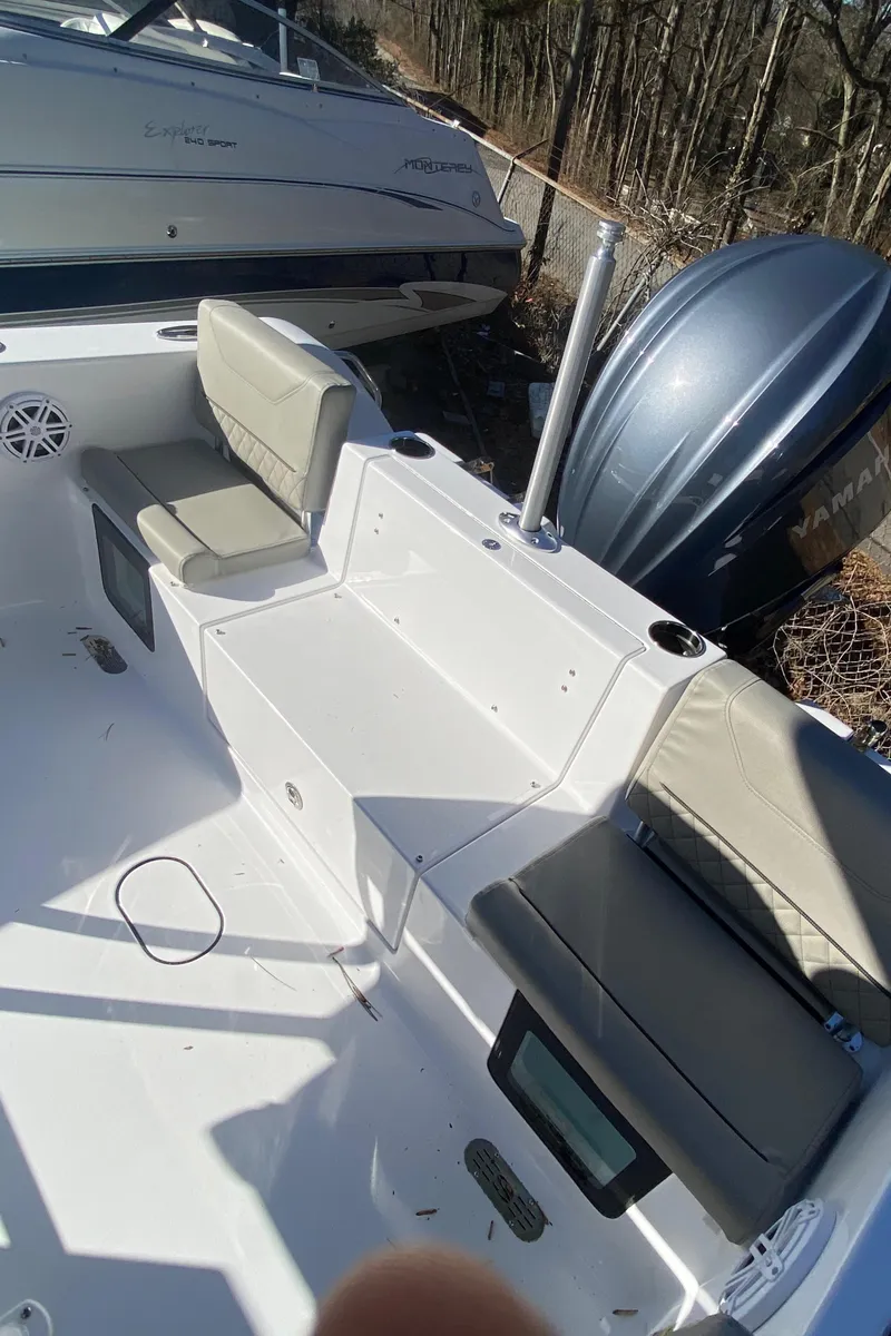 Slide: The Image of 2025 Sportsman Heritage 231 Center Console boat interior with seating and engine view. - 6