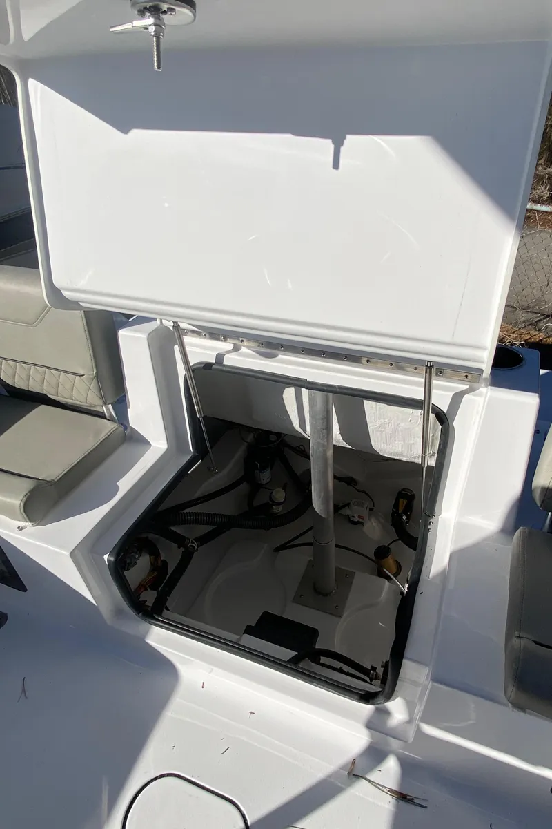 Slide: The Image of 2025 Sportsman Heritage 231 Center Console boat storage compartment open. - 7