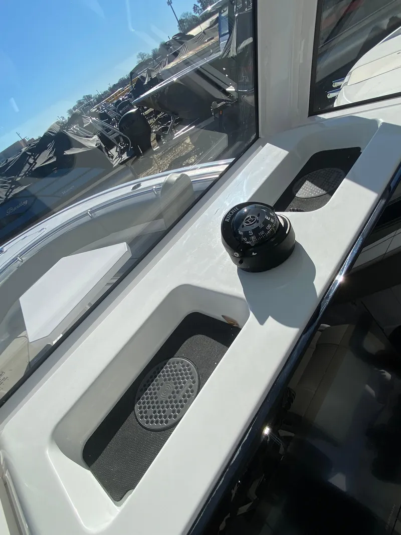 Slide: The Image of 2025 Sportsman Heritage 231 Center Console interior with compass and storage compartments. - 9