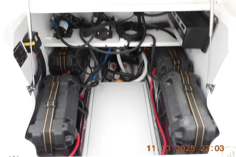Slide: The Image of 2025 Sea Fox 288 Traveler boat battery compartment with wiring and equipment. - 14