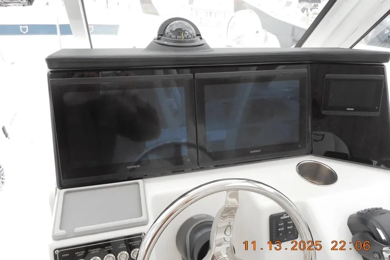 Slide: The Image of Control panel of 2025 Sea Fox 288 Traveler with dual Garmin displays and compass. - 20