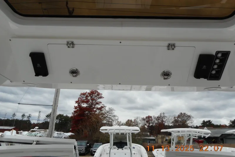 Slide: The Image of 2025 Sea Fox 288 Traveler boat interior with overhead storage and control panel. - 23