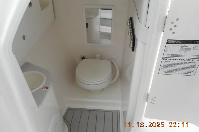 Slide: The Image of 2025 Sea Fox 288 Traveler boat bathroom interior with toilet and sink. - 25