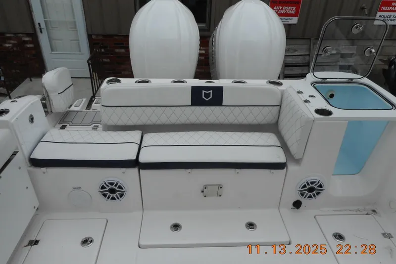 Slide: The Image of 2025 Sea Fox 288 Traveler boat interior with cushioned seating and storage compartments. - 28