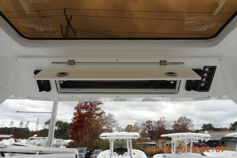Slide: The Image of 2025 Sea Fox 288 Traveler boat interior with open storage compartment and control panel. - 36