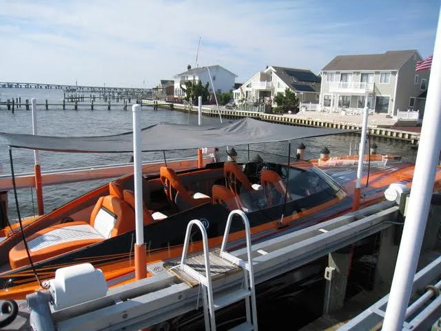 Slide: The Image of 2024 Mystic Powerboats C4000 docked by waterfront homes. - 20
