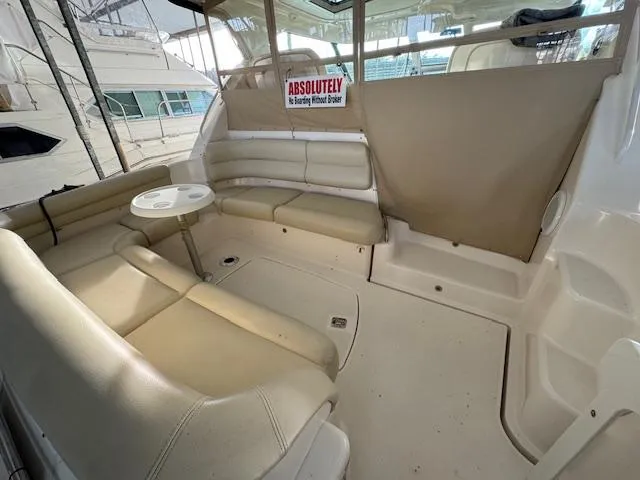 Slide: The Image of 2007 Tiara Yachts 4300 Sovran interior with beige seating and small table. - 11