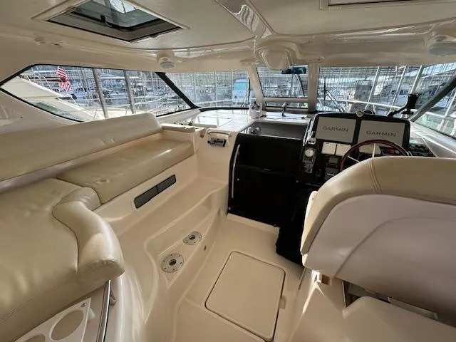 Slide: The Image of 2007 Tiara Yachts 4300 Sovran interior with beige seating and navigation equipment. - 12