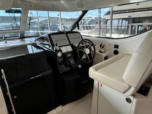 Slide: The Image of 2007 Tiara Yachts 4300 Sovran helm with Garmin navigation and leather seating. - 13